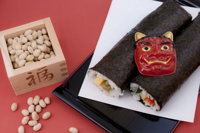 Visitors scramble to collect beans during a Setsubun festival at