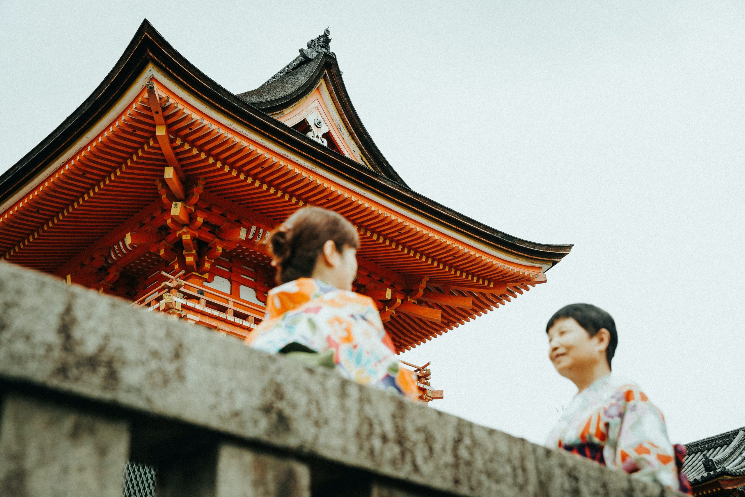 japanese women talking in front a shrine