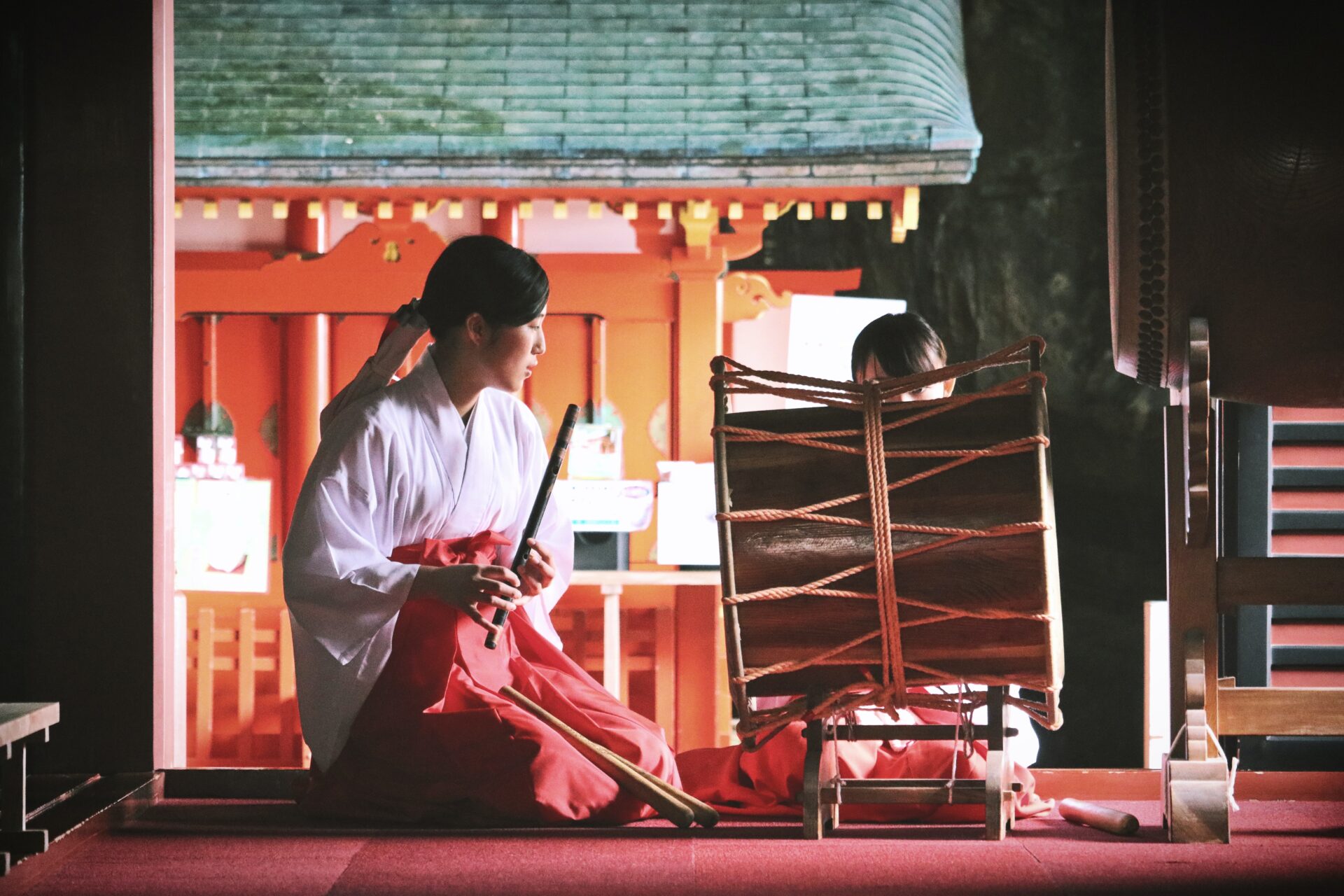 Woman playing drum at shrine